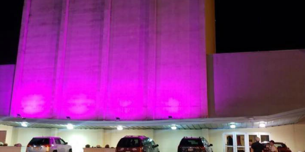 Neon pink lights shining on the side of Youngstown Playhouse