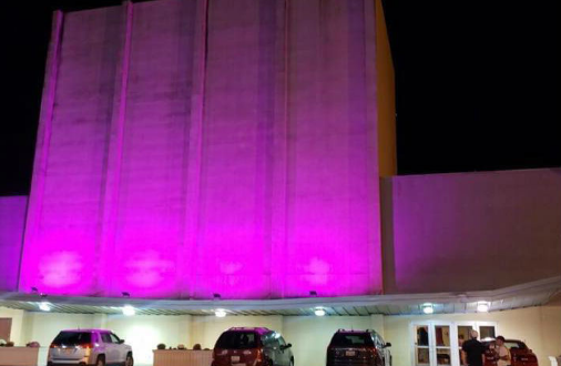 Neon pink lights shining on side of Youngstown Playhouse